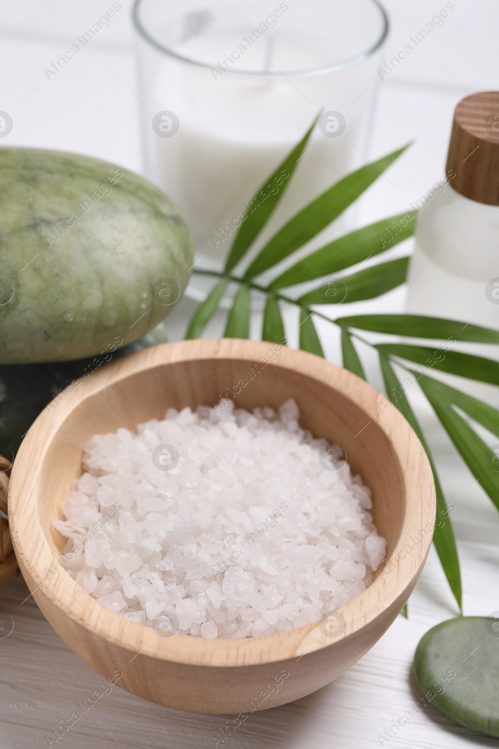 Photo of Beautiful spa composition with sea salt on white wooden table