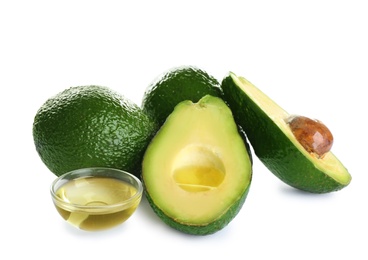 Photo of Bowl of natural oil and avocados isolated on white