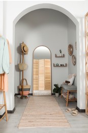 Photo of Hallway interior with stylish furniture and floor mirror