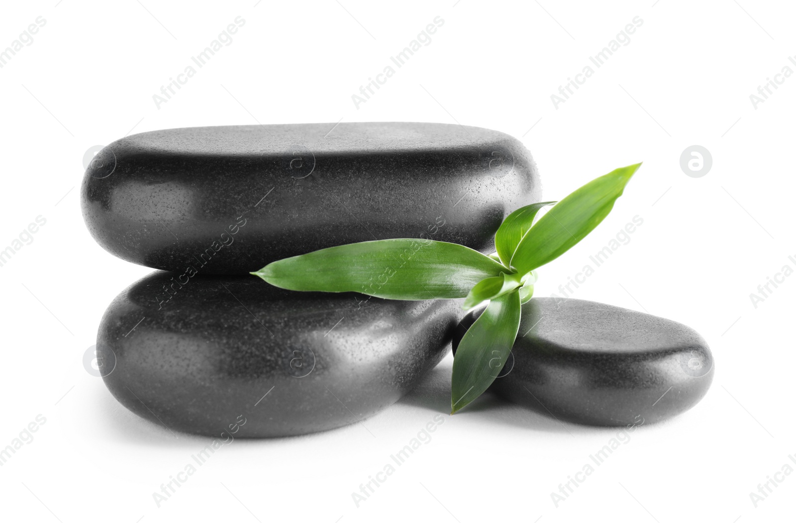 Photo of Black spa stones with bamboo isolated on white