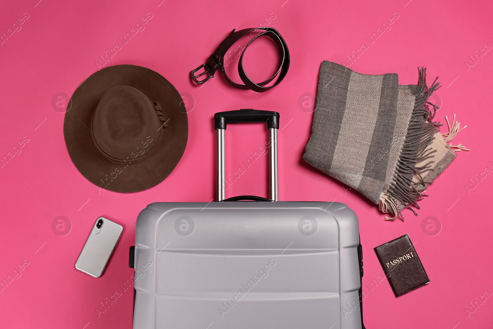 Photo of Flat lay composition with suitcase and traveler's accessories on color background