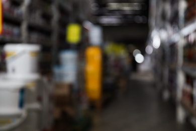 Photo of Blurred view of storage stands with different building materials in wholesale warehouse