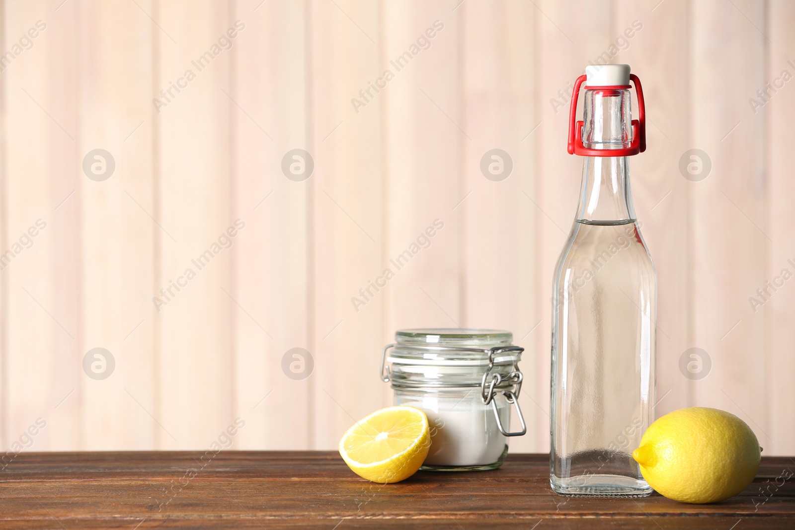 Photo of Composition with vinegar, lemons and baking soda on table. Space for text