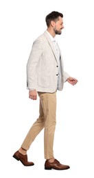 Photo of Man in stylish outfit walking on white background