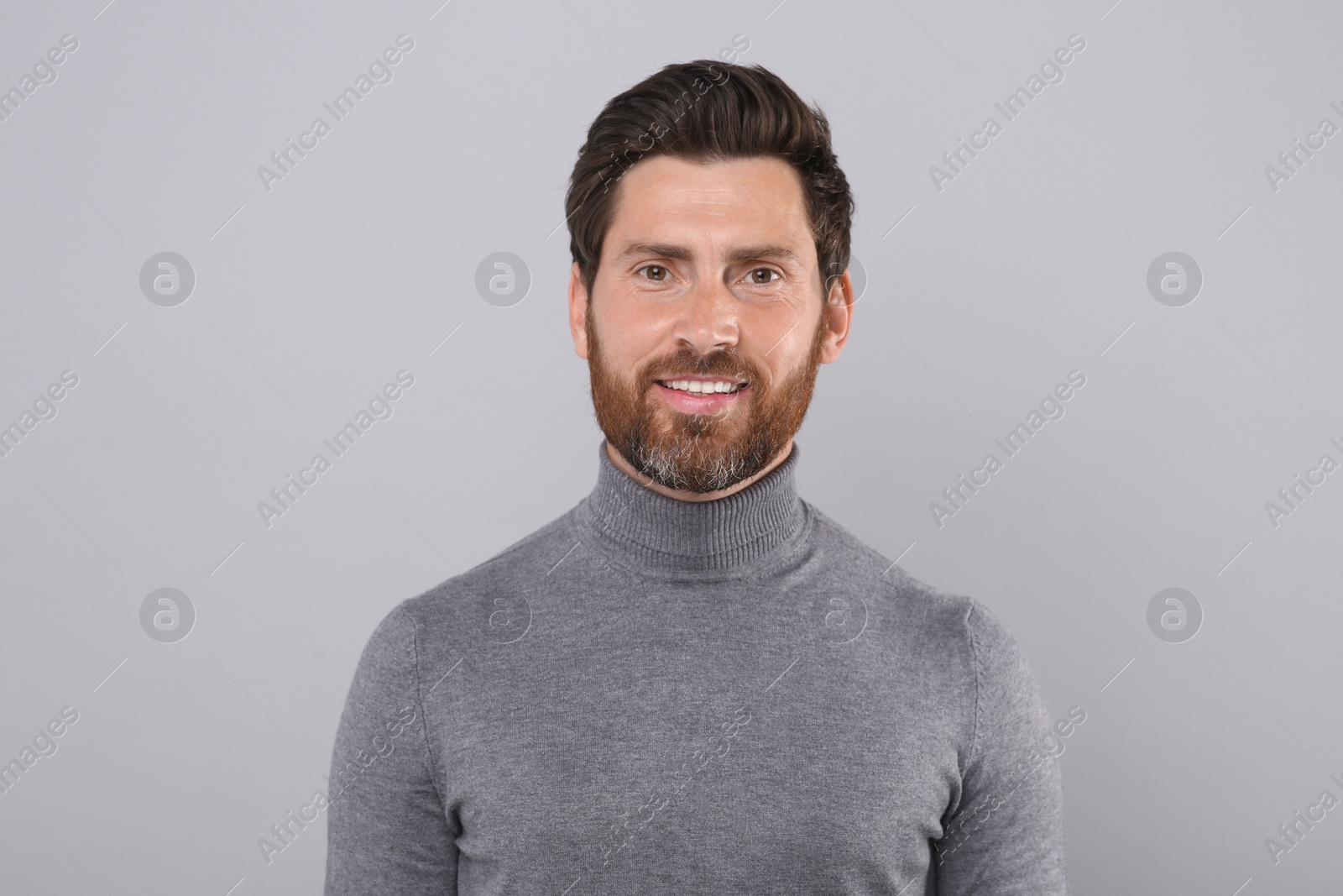 Photo of Portrait of handsome man on light grey background