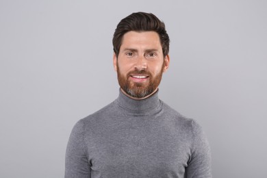 Portrait of handsome man on light grey background