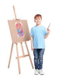 Photo of Little boy with brush near eassel on white background. Creative hobby