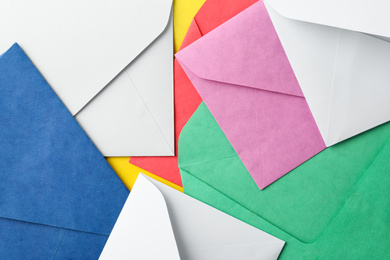 Colorful paper envelopes as background, top view