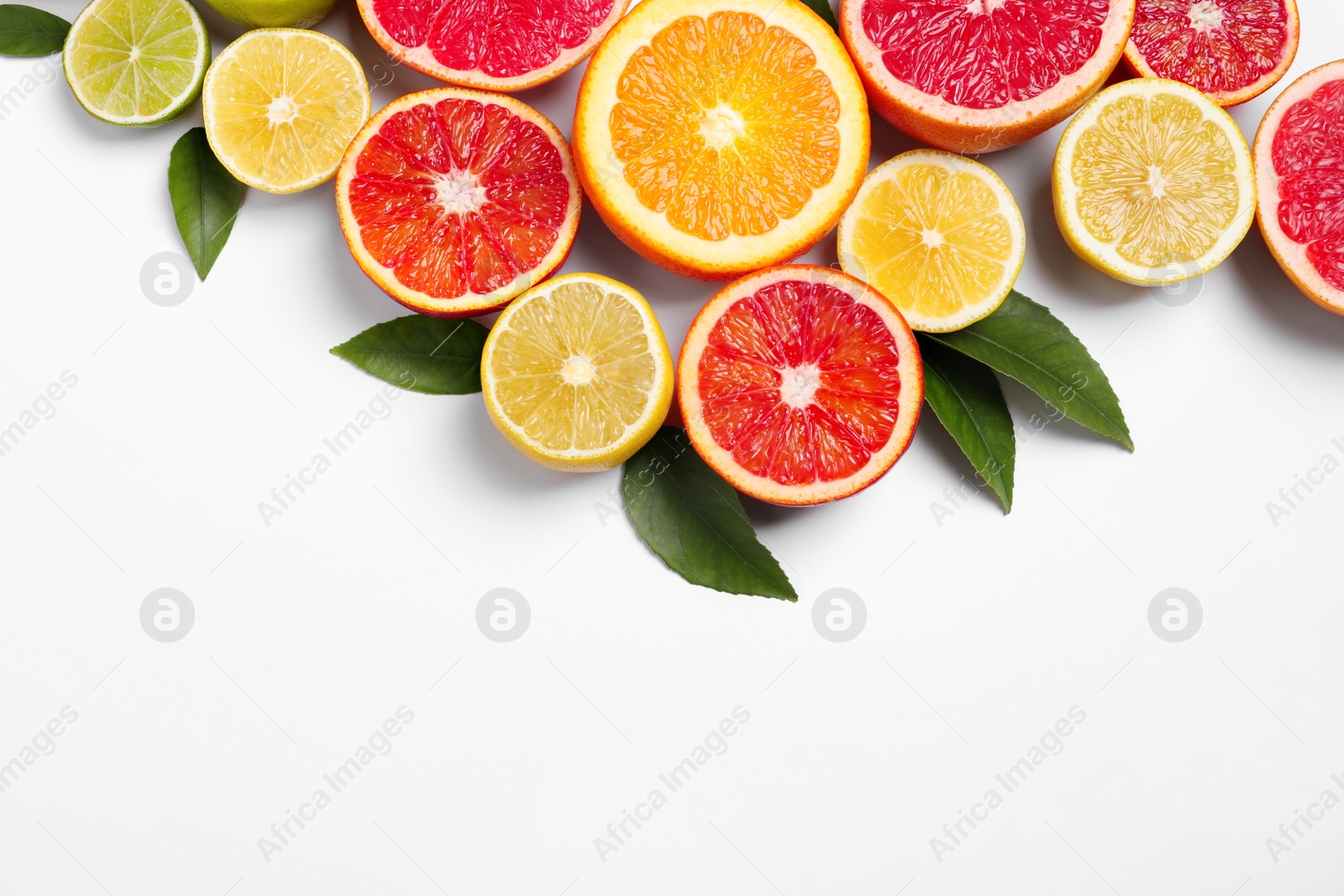 Photo of Fresh juicy citrus fruits with green leaves on white background, flat lay. Space for text