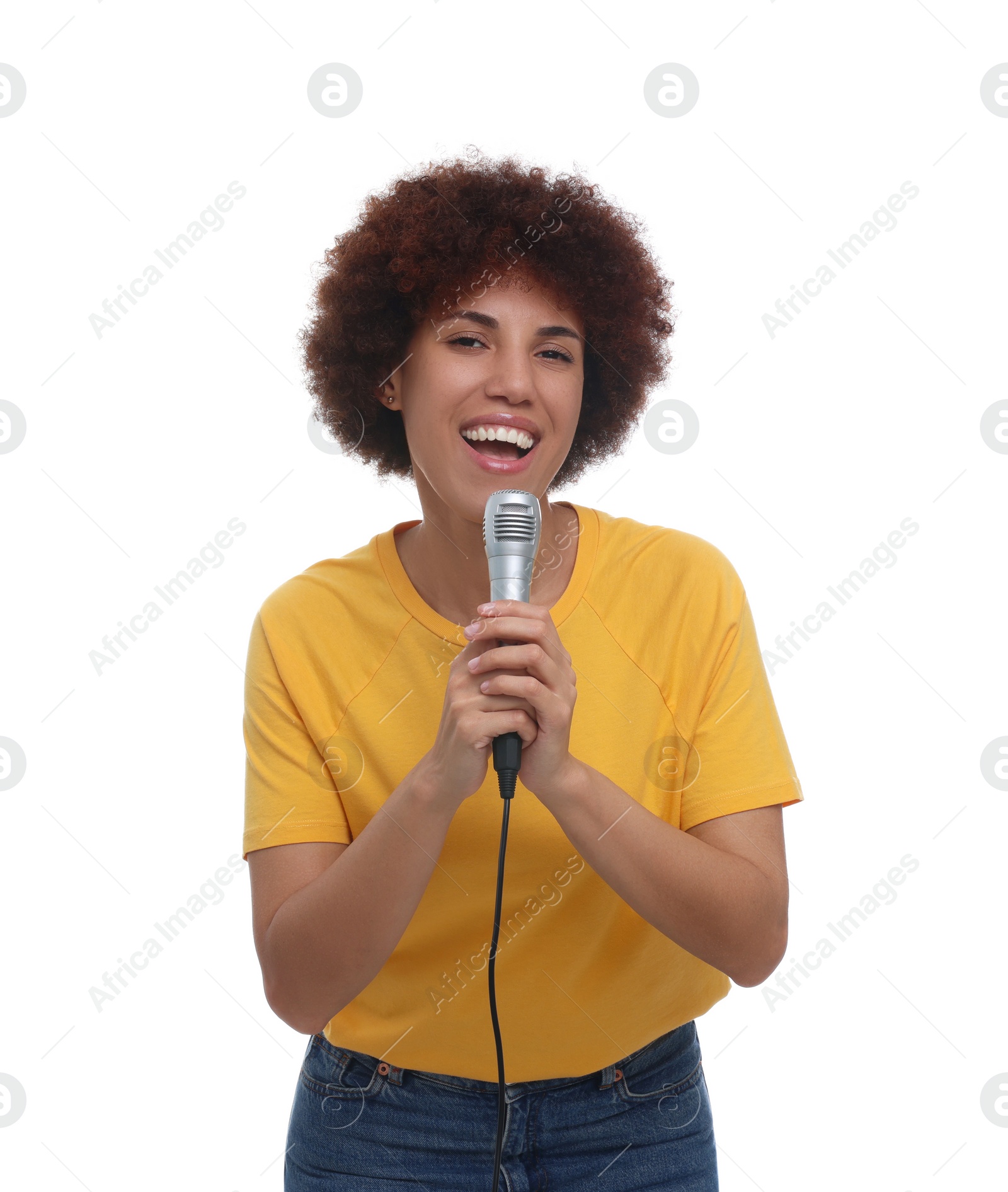 Photo of Curly young woman with microphone singing on white background