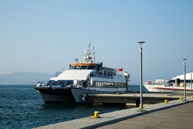 Photo of Picturesque view of ferry moored in sea port on sunny day