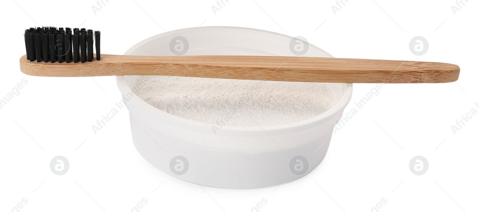 Photo of Bowl of tooth powder and brush on white background