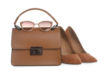 Photo of Stylish woman's bag, sunglasses and shoes isolated on white