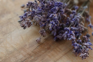 Photo of Beautiful lavender flowers on wooden table, closeup. Space for text