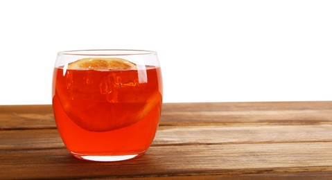 Photo of Aperol spritz cocktail and orange slices in glass on wooden table against white background