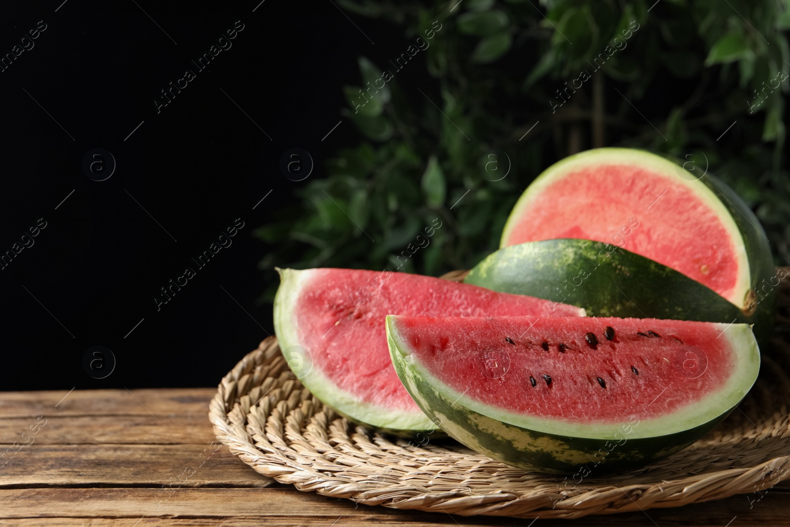 Photo of Delicious fresh watermelon slices on wooden table. Space for text