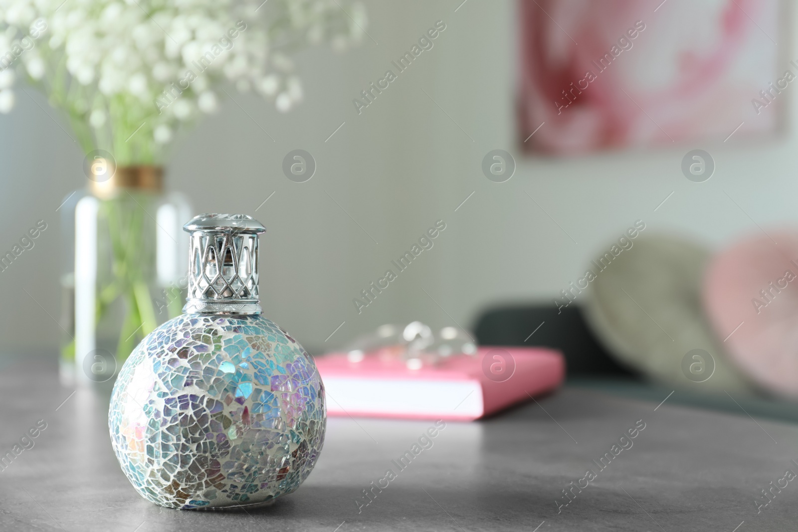 Photo of Stylish catalytic lamp on grey table in room, space for text. Cozy interior