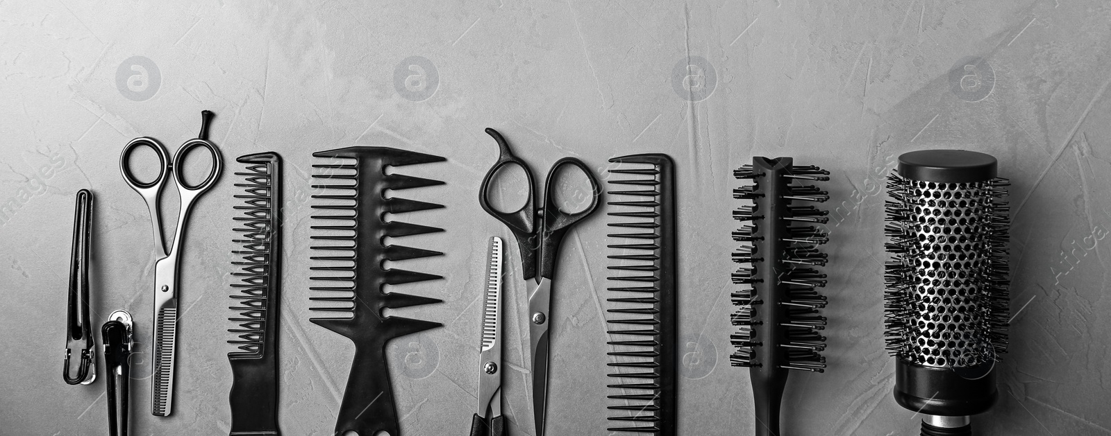 Image of Set of different professional hairdresser tools on grey background, flat lay. Banner design