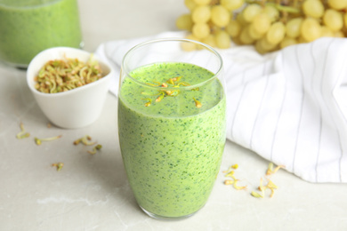 Photo of Green buckwheat smoothie on light grey marble table