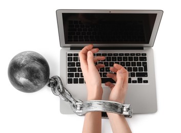 Woman shackled with ball and chain near laptop on white background, top view. Internet addiction