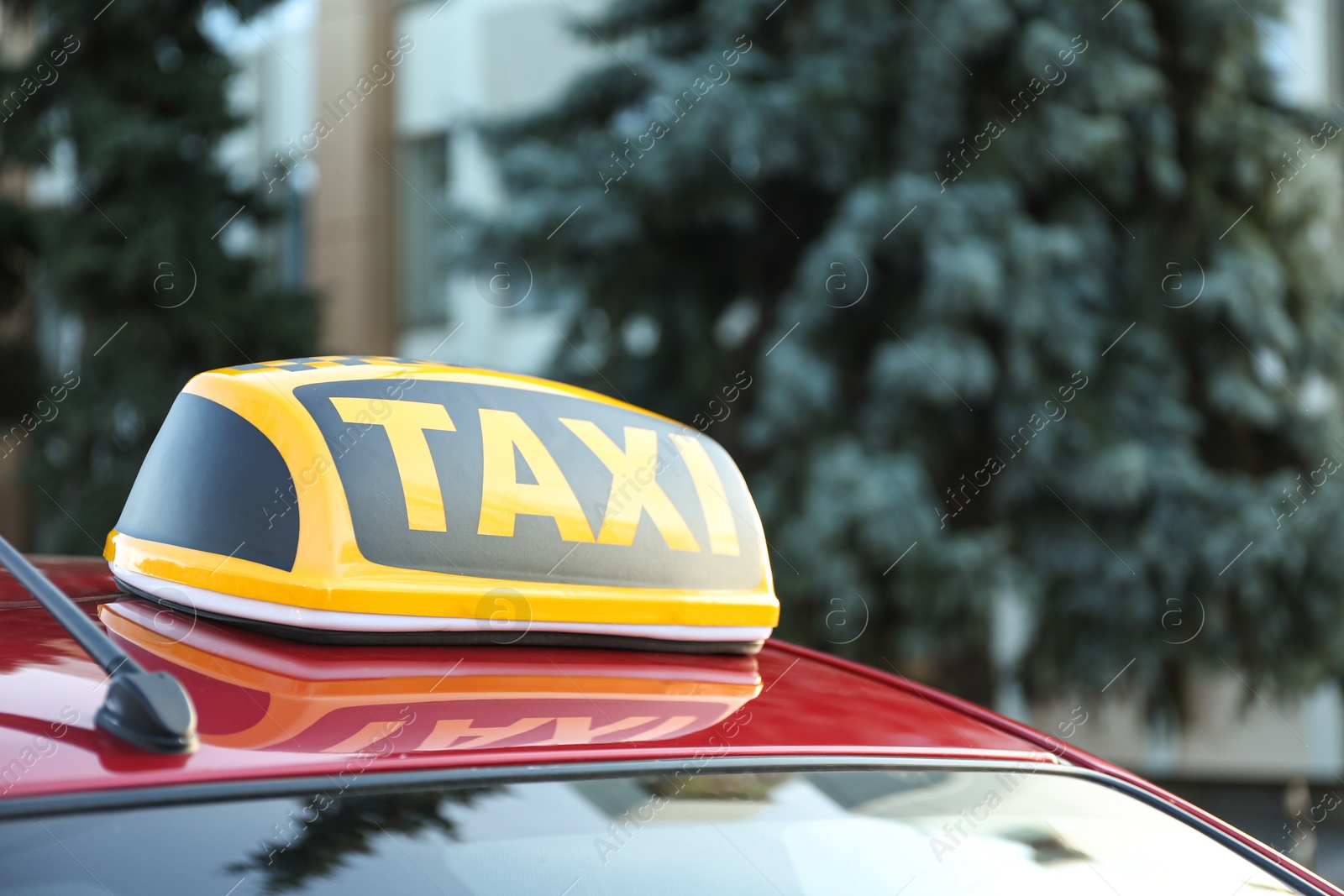 Photo of Roof light with word TAXI on car outdoors