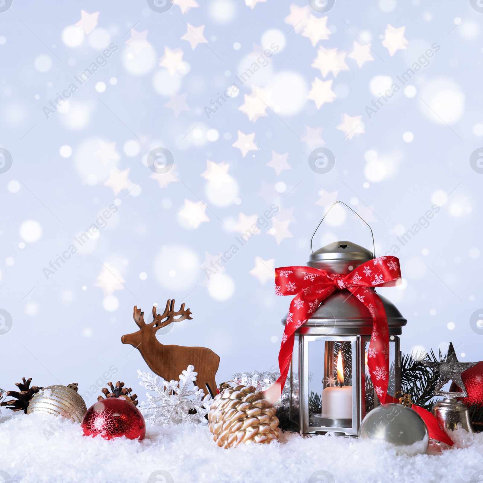 Image of Composition with Christmas lantern on snow. Bokeh effect