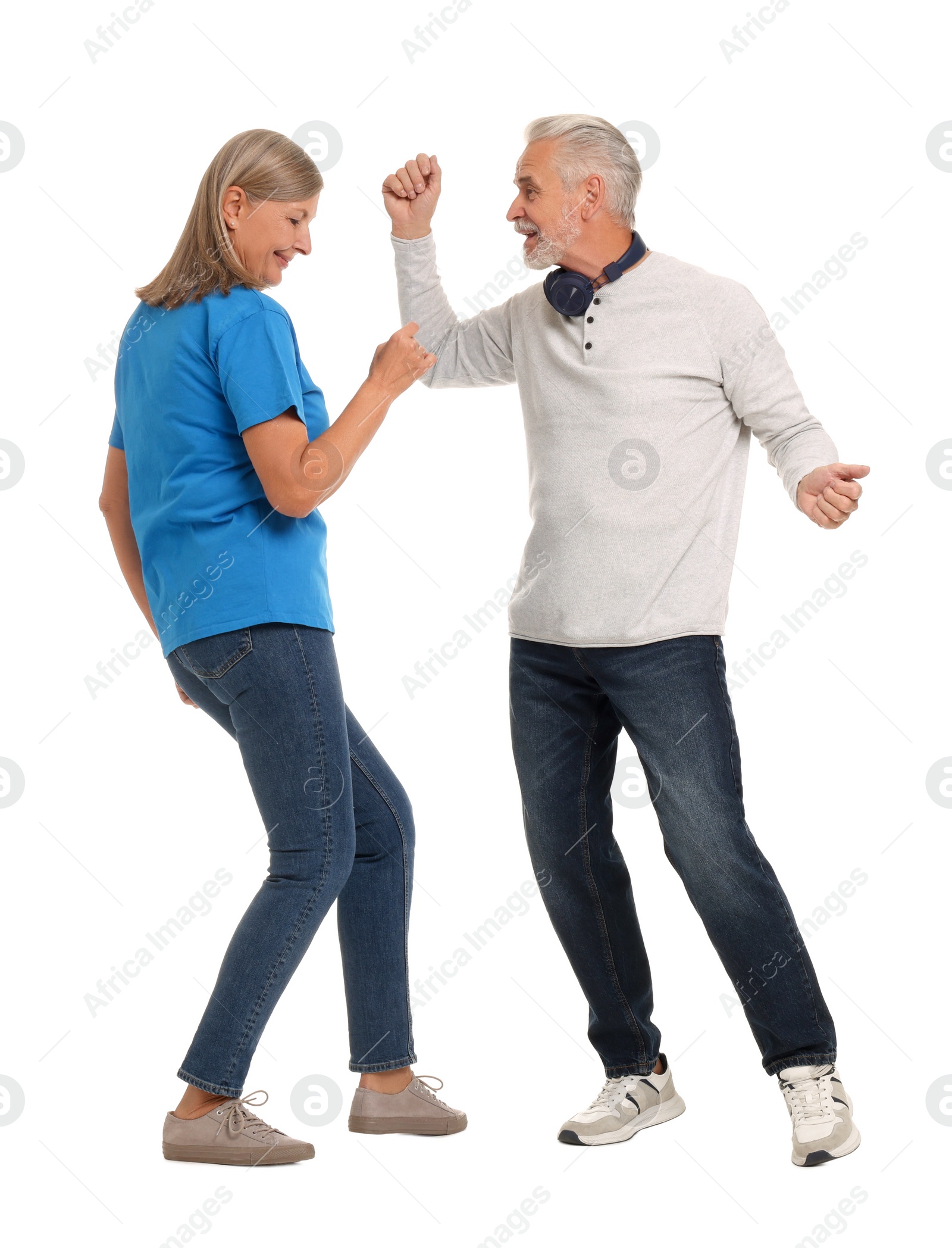 Photo of Senior couple dancing together on white background