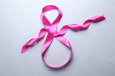 8 March greeting card design with pink ribbon on light grey background, top view. International Women's day