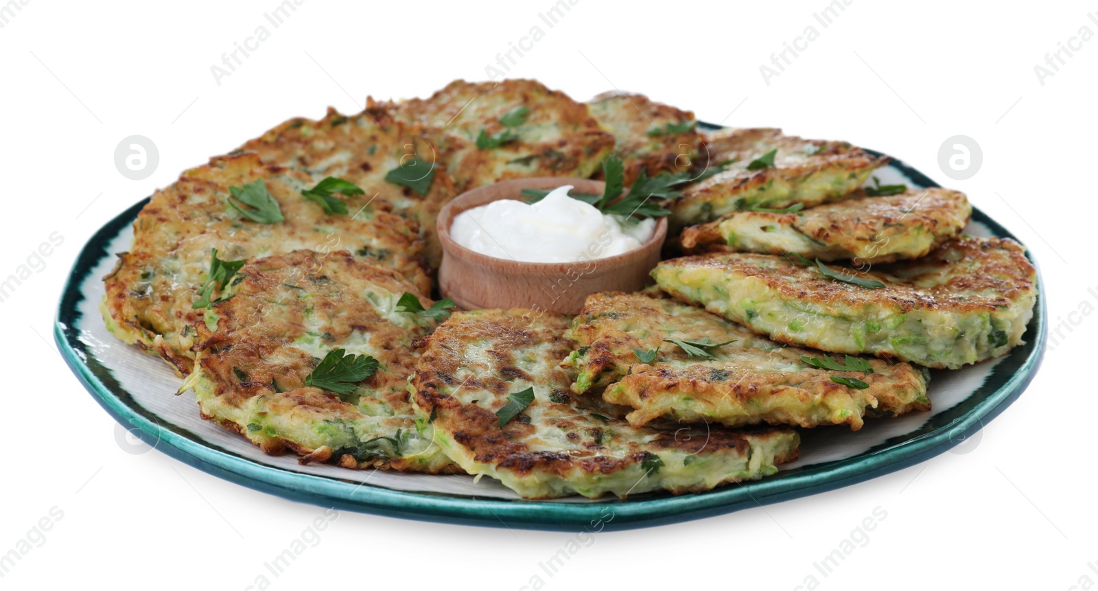 Photo of Delicious zucchini fritters with sour cream on white background