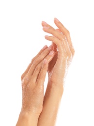 Young woman applying natural scrub on hands against white background