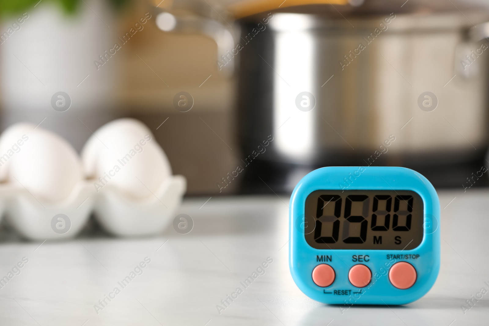 Photo of Digital kitchen timer on white table indoors. Space for text