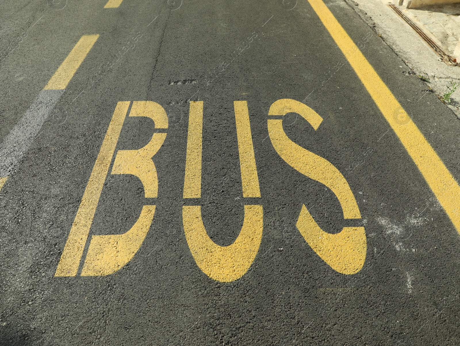 Photo of Bus stop pad on asphalt road on sunny day