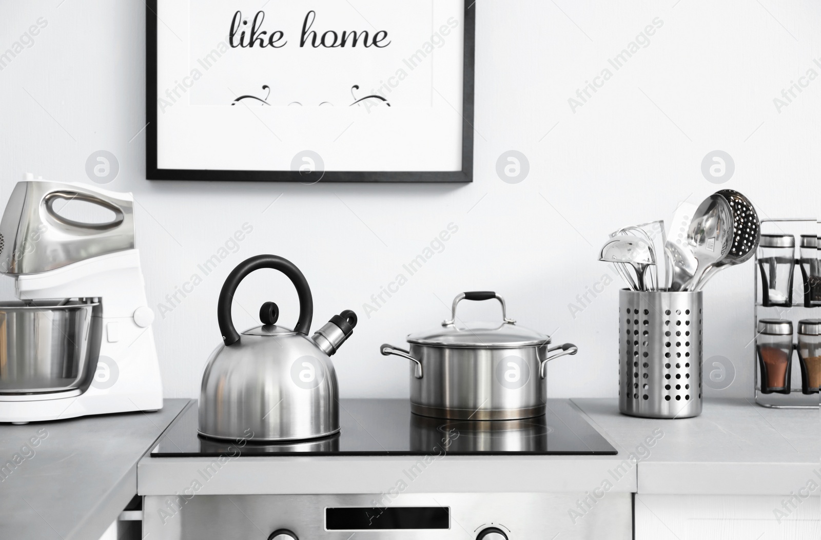 Photo of Modern kitchen interior with new furniture and different utensils