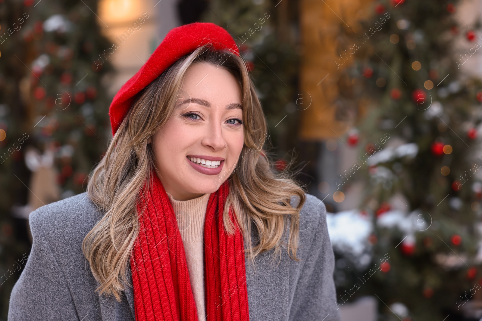 Photo of Portrait of smiling woman on city street in winter. Space for text