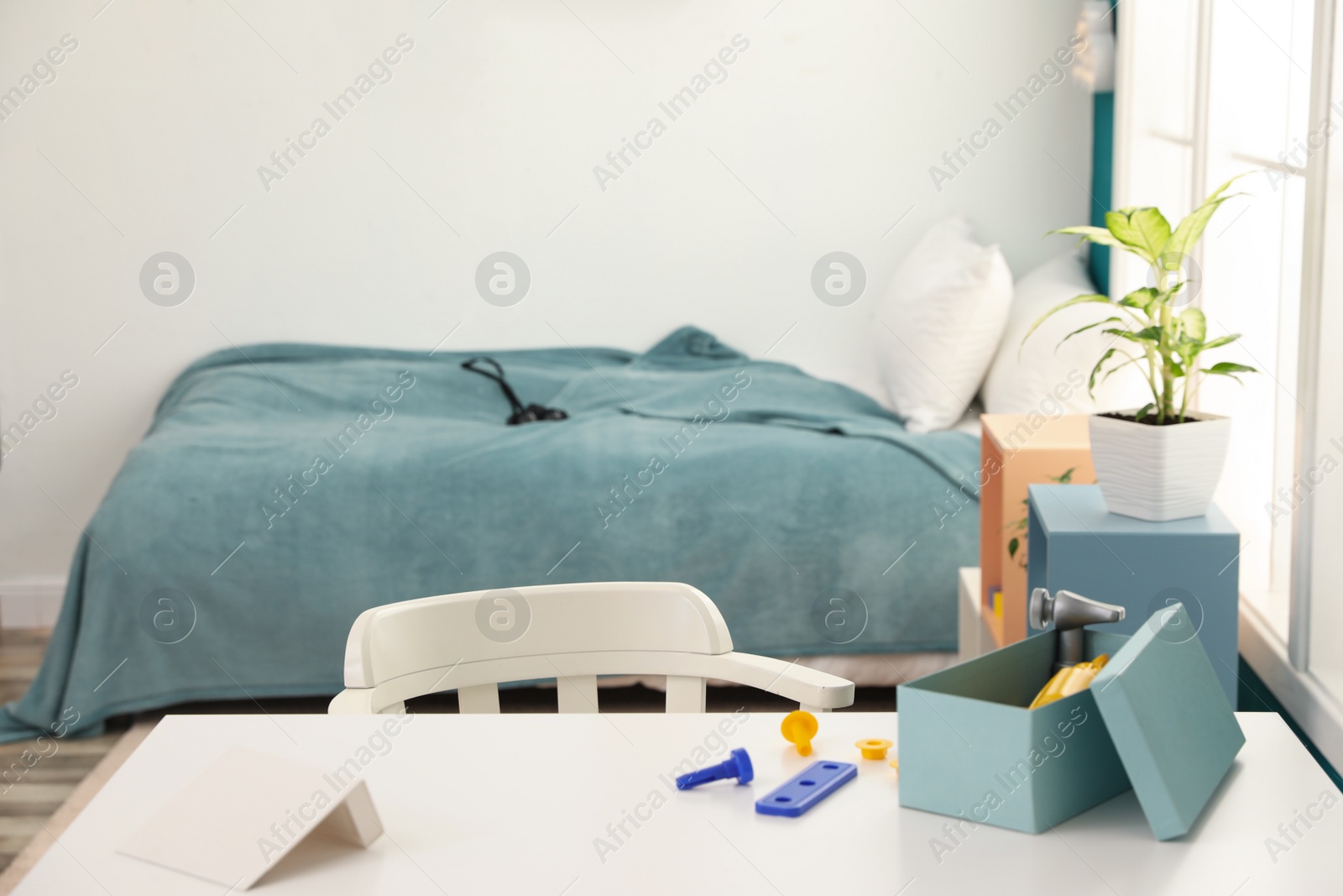 Photo of Modern child room interior with desk and comfortable bed