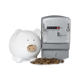 Photo of Electricity meter, piggy bank and coins on white background