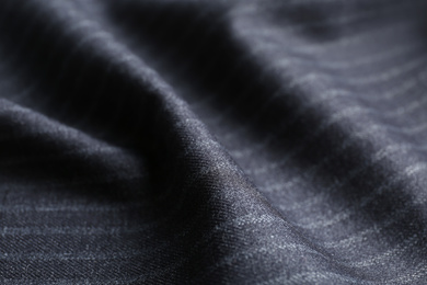 Photo of Texture of dark striped fabric as background, closeup