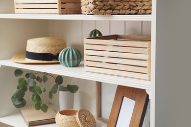 Photo of White shelving unit with different decorative stuff