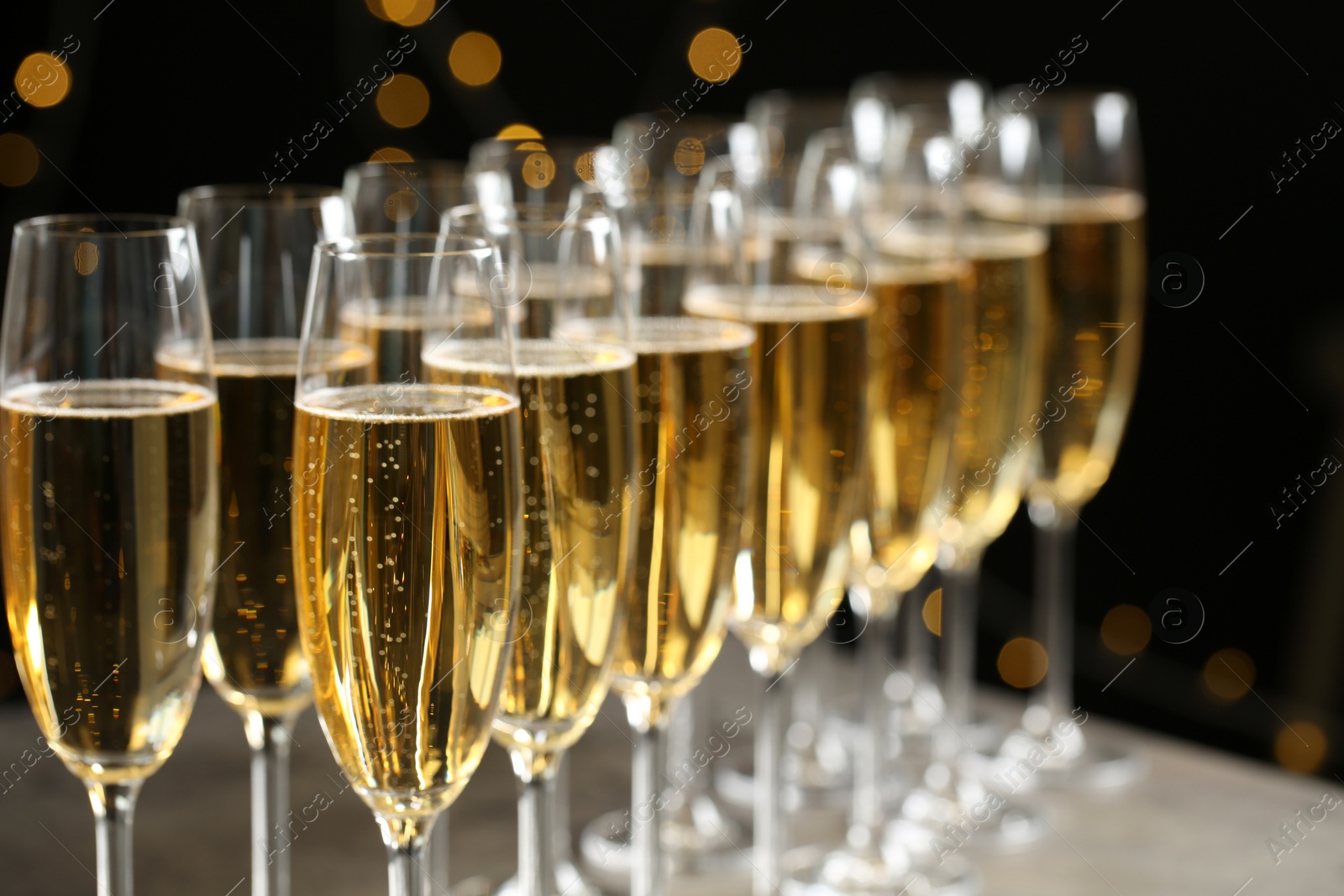 Photo of Glasses of champagne on blurred background, closeup. Space for text