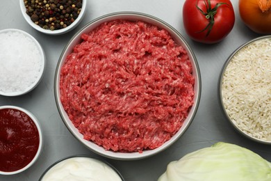 Photo of Set of ingredients for preparing stuffed cabbage rolls on light grey table, flat lay