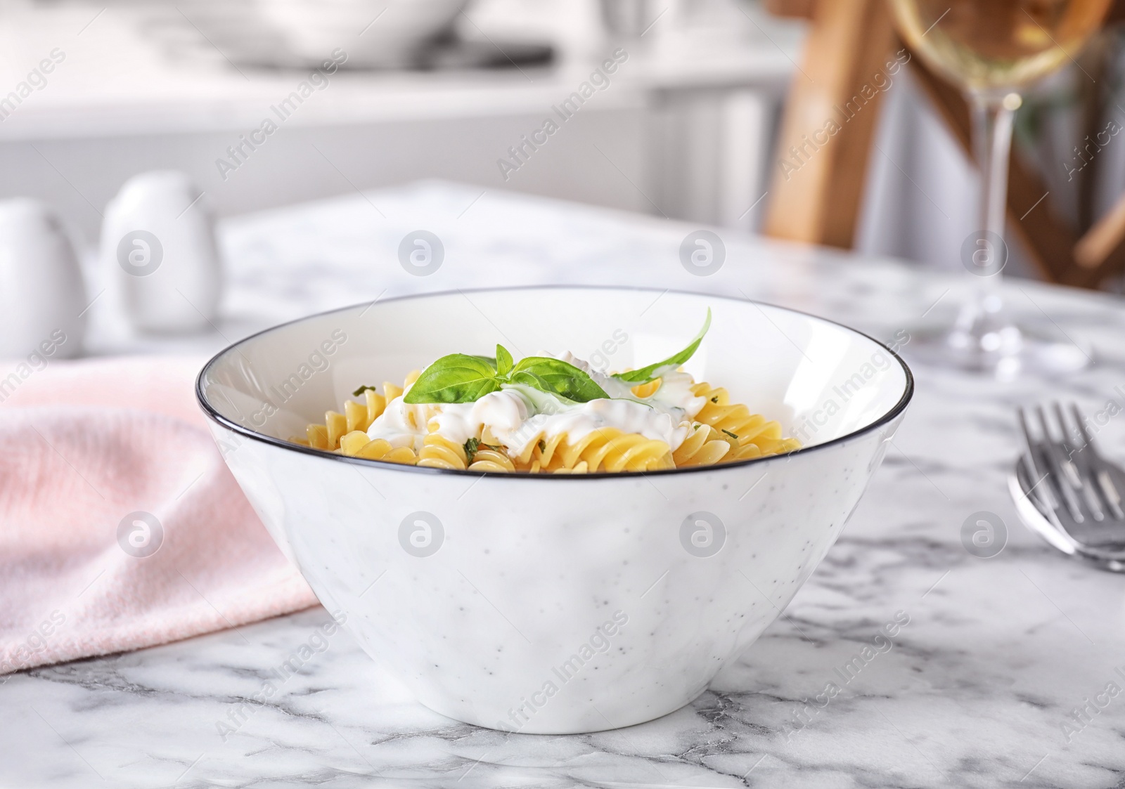 Photo of Delicious pasta with sauce served on white marble table