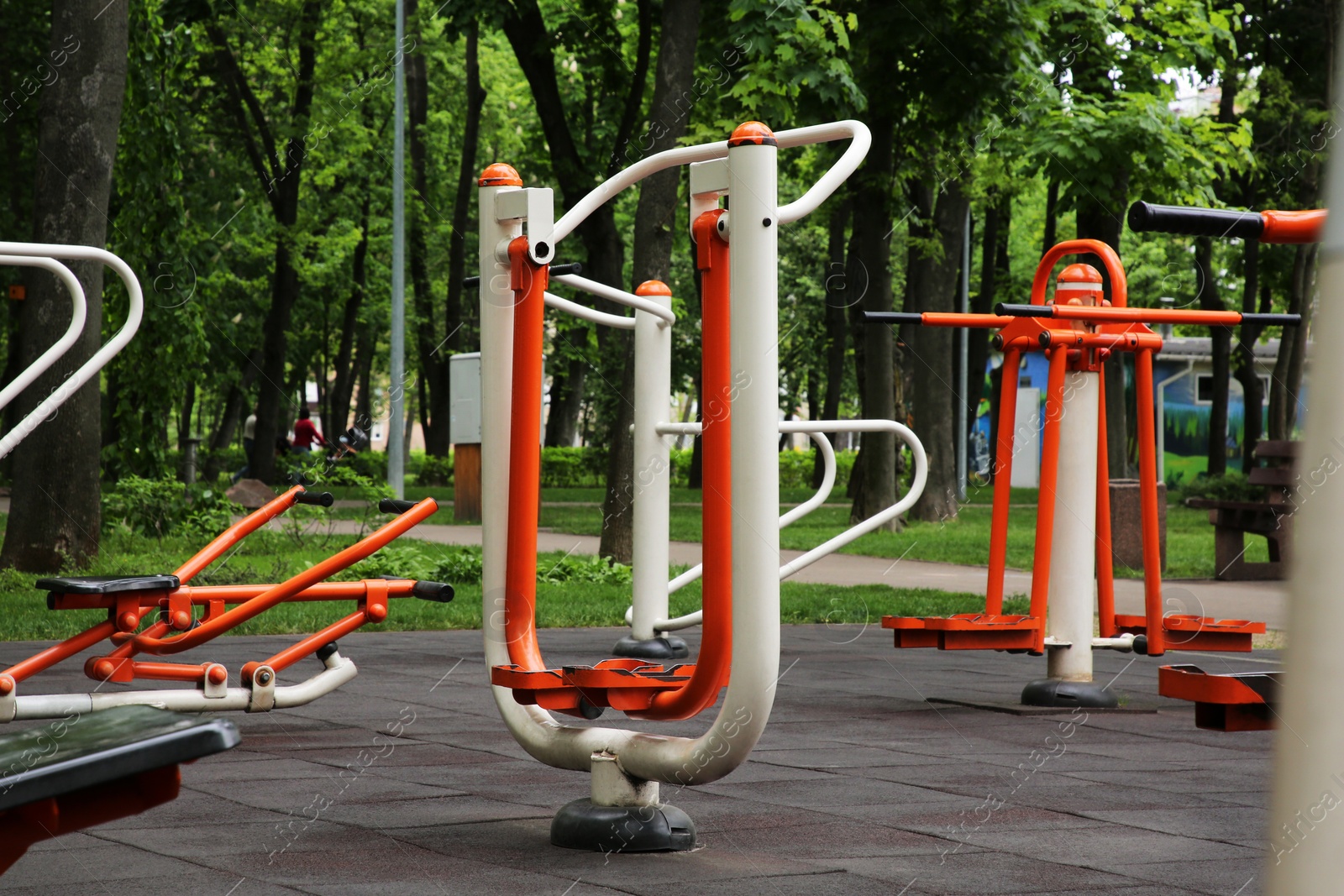 Photo of Empty outdoor gym with air walker, push up bars, rowing machine and double abductor