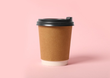 Photo of Takeaway paper coffee cup on pink background