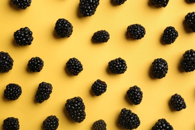 Photo of Flat lay composition with fresh blackberries on yellow background