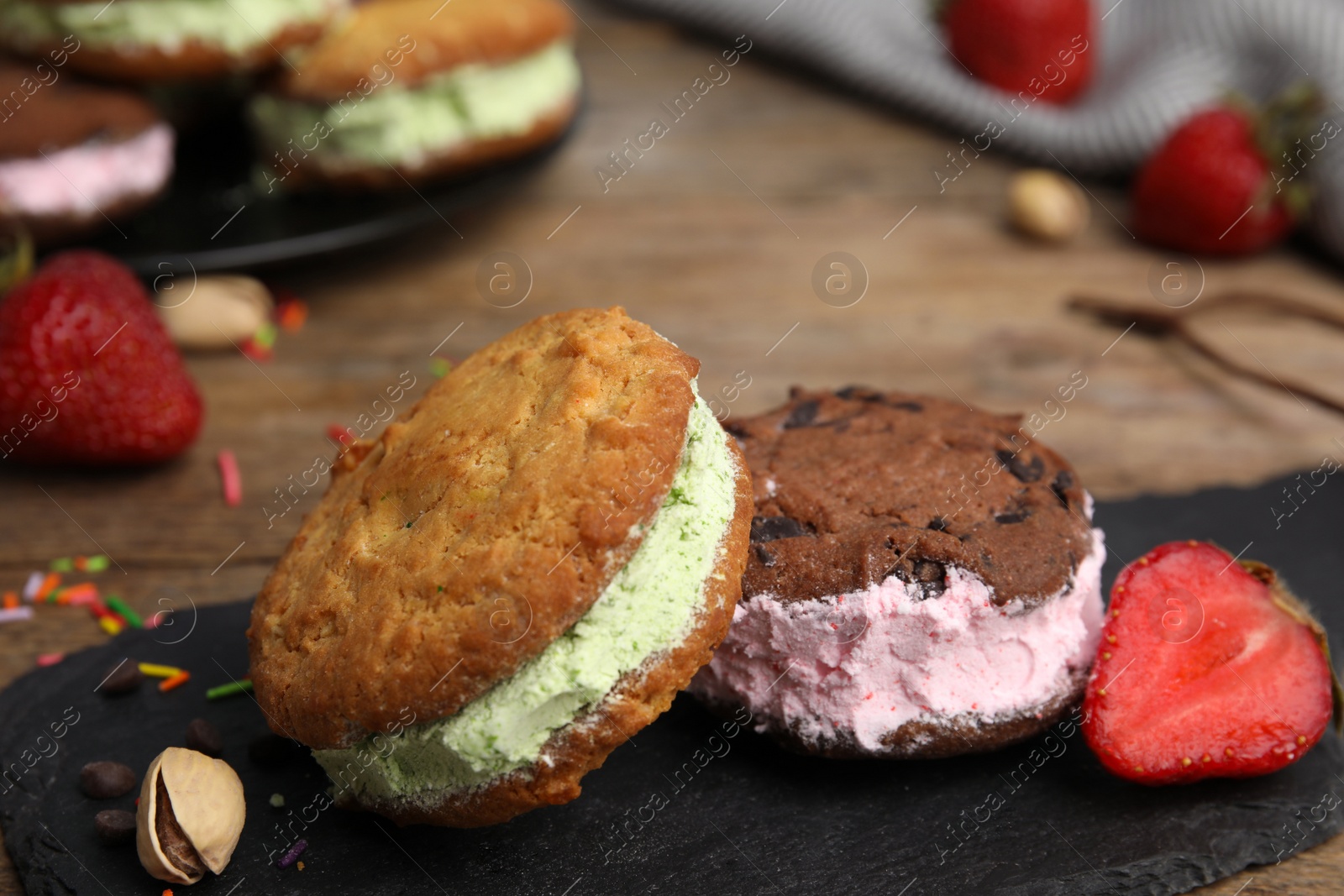 Photo of Sweet delicious ice cream cookie sandwiches on table