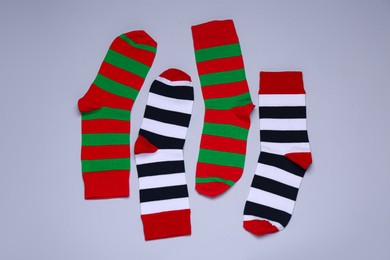 Photo of Different striped socks on grey background, flat lay