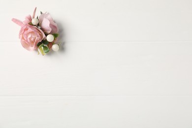 Photo of Beautiful boutonniere on white background, top view. Space for text