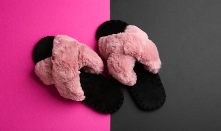 Photo of Pair of soft slippers on color background, flat lay