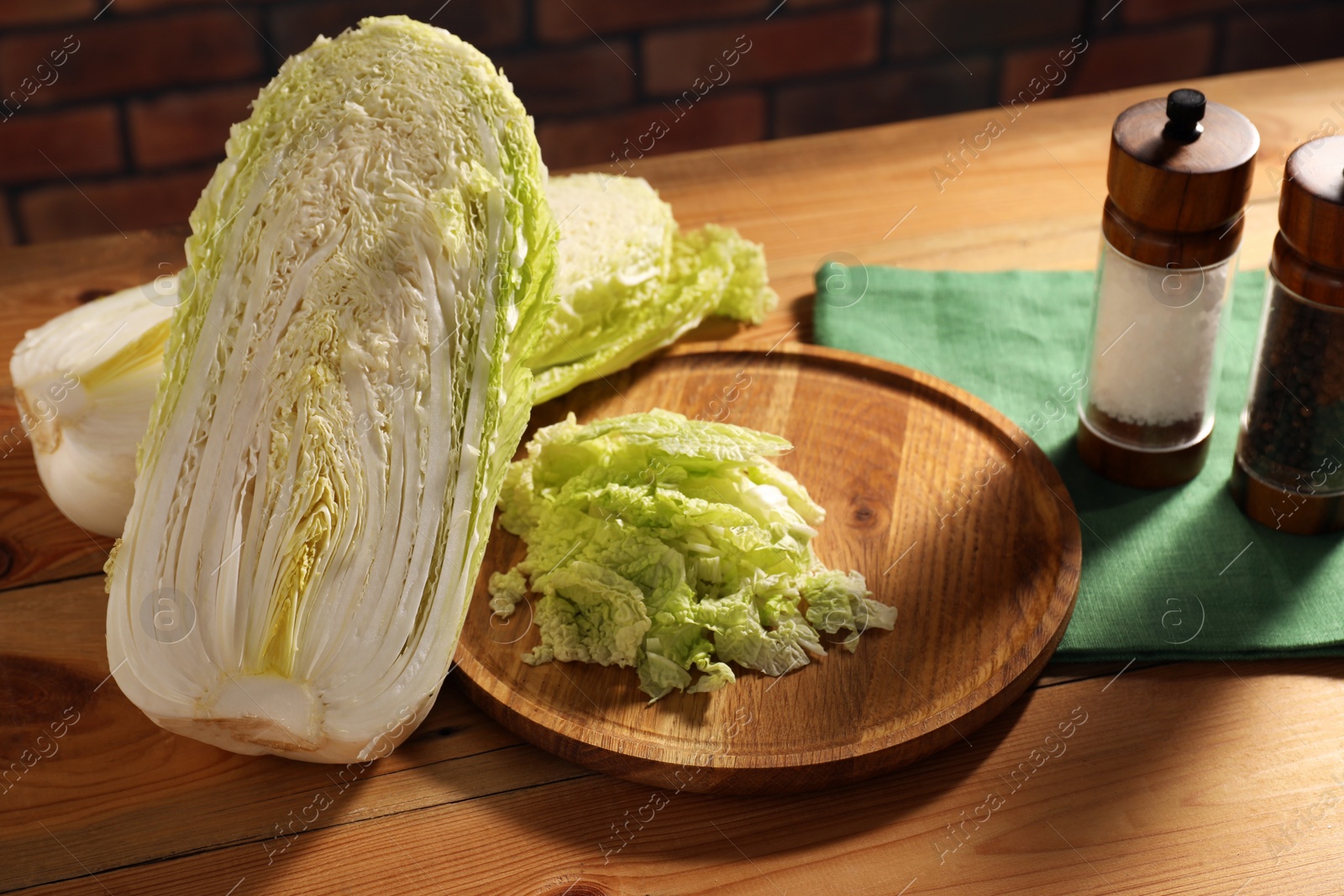 Photo of Fresh Chinese cabbage and spices on wooden table