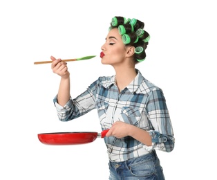 Photo of Funny young housewife frying pan tasting prepared dish on white background